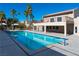 Inviting community pool with adjacent building and palm trees at 4480 Sandy River Dr # 64, Las Vegas, NV 89103