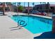 Community pool with blue, clear water, and surrounding patio at 4480 Sandy River Dr # 64, Las Vegas, NV 89103