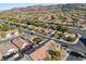 Panoramic aerial shot featuring a neighborhood with tree-lined streets and mountain views at 511 Dalgreen Pl, Henderson, NV 89012