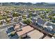 Aerial view of a quiet neighborhood on a sunny day, showcasing the single-Gathering homes and surroundings at 511 Dalgreen Pl, Henderson, NV 89012