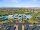 Community aerial view featuring a golf course, clubhouse, pool, parking lot, and beautiful mountain views at 511 Dalgreen Pl, Henderson, NV 89012