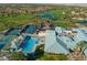 Beautiful aerial view of the neighborhood clubhouse with a pool, spa, tennis courts, and golf course at 511 Dalgreen Pl, Henderson, NV 89012