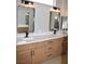 Double vanity bathroom with modern light fixtures and mirrors at 511 Dalgreen Pl, Henderson, NV 89012