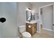 Modern bathroom featuring a stylish vanity, framed mirror, and sleek walk-in shower with tile surround at 511 Dalgreen Pl, Henderson, NV 89012