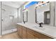 Modern bathroom with double vanity, large shower, and light wood cabinets at 511 Dalgreen Pl, Henderson, NV 89012