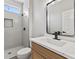 Modern bathroom with a walk-in shower and wood vanity at 511 Dalgreen Pl, Henderson, NV 89012