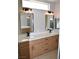 Double vanity bathroom with modern light fixtures and mirrors at 511 Dalgreen Pl, Henderson, NV 89012