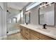 Modern bathroom featuring double vanity, granite countertops, and a glass-enclosed shower at 511 Dalgreen Pl, Henderson, NV 89012