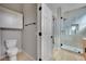 Bright bathroom featuring modern fixtures, cabinet storage, and a glass-enclosed shower at 511 Dalgreen Pl, Henderson, NV 89012