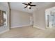 Large bright bedroom with ceiling fan, wood-look flooring, and an adjacent bathroom at 511 Dalgreen Pl, Henderson, NV 89012