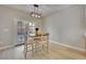 Bright dining space featuring modern light fixture, neutral walls, and patio access at 511 Dalgreen Pl, Henderson, NV 89012