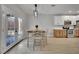 Cozy dining area with stylish table set next to bright patio doors and modern kitchen at 511 Dalgreen Pl, Henderson, NV 89012