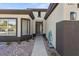 Exterior shot of a single story home with a stone yard and covered front porch with an outdoor light fixture at 511 Dalgreen Pl, Henderson, NV 89012