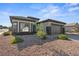 Single story stucco home with a stone yard, a covered entry and an attached two car garage at 511 Dalgreen Pl, Henderson, NV 89012