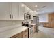 Kitchen has stainless appliances, white and wood cabinets and quartz countertops at 511 Dalgreen Pl, Henderson, NV 89012