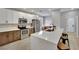 Modern kitchen with stainless steel appliances, a large island, and white and wood cabinetry at 511 Dalgreen Pl, Henderson, NV 89012