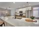 Bright kitchen with quartz countertops, stainless steel appliances, and seating at the island at 511 Dalgreen Pl, Henderson, NV 89012