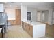 Modern kitchen with light wood cabinets, quartz countertops, and an island at 511 Dalgreen Pl, Henderson, NV 89012