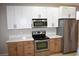 Modern kitchen featuring stainless steel appliances and light wood cabinets at 511 Dalgreen Pl, Henderson, NV 89012