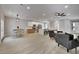 Spacious living room with light wood floors, a dining area, and a modern open kitchen at 511 Dalgreen Pl, Henderson, NV 89012