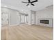 Spacious living room featuring a modern fireplace and light hardwood floors at 511 Dalgreen Pl, Henderson, NV 89012