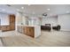 Open-concept living area with wood floors, fireplace, and island with waterfall countertops at 511 Dalgreen Pl, Henderson, NV 89012