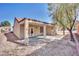 View of the home's exterior patio space with stone ground cover and a covered porch with painted concrete at 511 Dalgreen Pl, Henderson, NV 89012