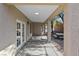 Covered patio area with concrete flooring, outdoor ceiling light, double doors and an adjacent picnic table at 511 Dalgreen Pl, Henderson, NV 89012