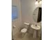 Clean and updated bathroom with pedestal sink and oval mirror at 529 Beckton Park Ave, Las Vegas, NV 89178