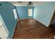 Light blue bedroom with wood-look floors and two windows at 529 Beckton Park Ave, Las Vegas, NV 89178