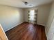 Bedroom with wood-look floors and window with curtains at 529 Beckton Park Ave, Las Vegas, NV 89178