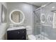 Modern bathroom with a large, round mirror and a walk-in shower at 6008 Carmel Way, Las Vegas, NV 89108