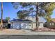 House exterior featuring a two-car garage and landscaping at 6008 Carmel Way, Las Vegas, NV 89108