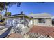 House exterior showcasing a two-car garage and stone landscaping at 6008 Carmel Way, Las Vegas, NV 89108