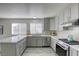 Modern kitchen with gray cabinets, quartz countertops and stainless steel appliances at 6008 Carmel Way, Las Vegas, NV 89108