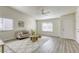 Living area with hardwood floors, a cozy seating area, and a ceiling fan at 6008 Carmel Way, Las Vegas, NV 89108