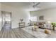 Bright living room with hardwood floors, comfy seating and a ceiling fan at 6008 Carmel Way, Las Vegas, NV 89108