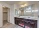 Double vanity bathroom with dark wood cabinets and a large mirror at 6217 Red Jamboree Ct, Las Vegas, NV 89130