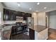 Modern kitchen with dark wood cabinets, granite countertops, and stainless steel appliances at 6217 Red Jamboree Ct, Las Vegas, NV 89130