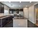 Modern kitchen with dark wood cabinets and granite countertops at 6217 Red Jamboree Ct, Las Vegas, NV 89130