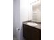 Bathroom with granite countertop, dark brown vanity, and toilet at 671 Anemone Ln, Henderson, NV 89015