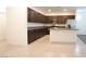 Modern kitchen with dark wood cabinets and granite countertops at 671 Anemone Ln, Henderson, NV 89015