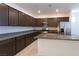 Modern kitchen with dark wood cabinets and granite countertops at 671 Anemone Ln, Henderson, NV 89015