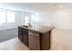 Kitchen island with granite countertop and stainless steel dishwasher at 671 Anemone Ln, Henderson, NV 89015