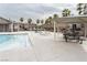 Community pool with a covered patio and lounge chairs at 671 Anemone Ln, Henderson, NV 89015