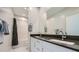 Modern bathroom with double sink vanity, large mirror, and shower at 6834 Compass St, North Las Vegas, NV 89084