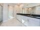 Bathroom showcasing modern double vanity and tiled glass shower enclosure at 6834 Compass St, North Las Vegas, NV 89084