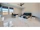 Spacious bedroom with sleek ceiling fan, windows, marble floors, and desk at 6834 Compass St, North Las Vegas, NV 89084