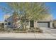 Single-story home with modern facade, landscaped yard, and attached garage at 6834 Compass St, North Las Vegas, NV 89084