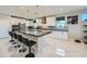 Modern kitchen featuring stainless steel appliances, a large island, and sleek white cabinets at 6834 Compass St, North Las Vegas, NV 89084